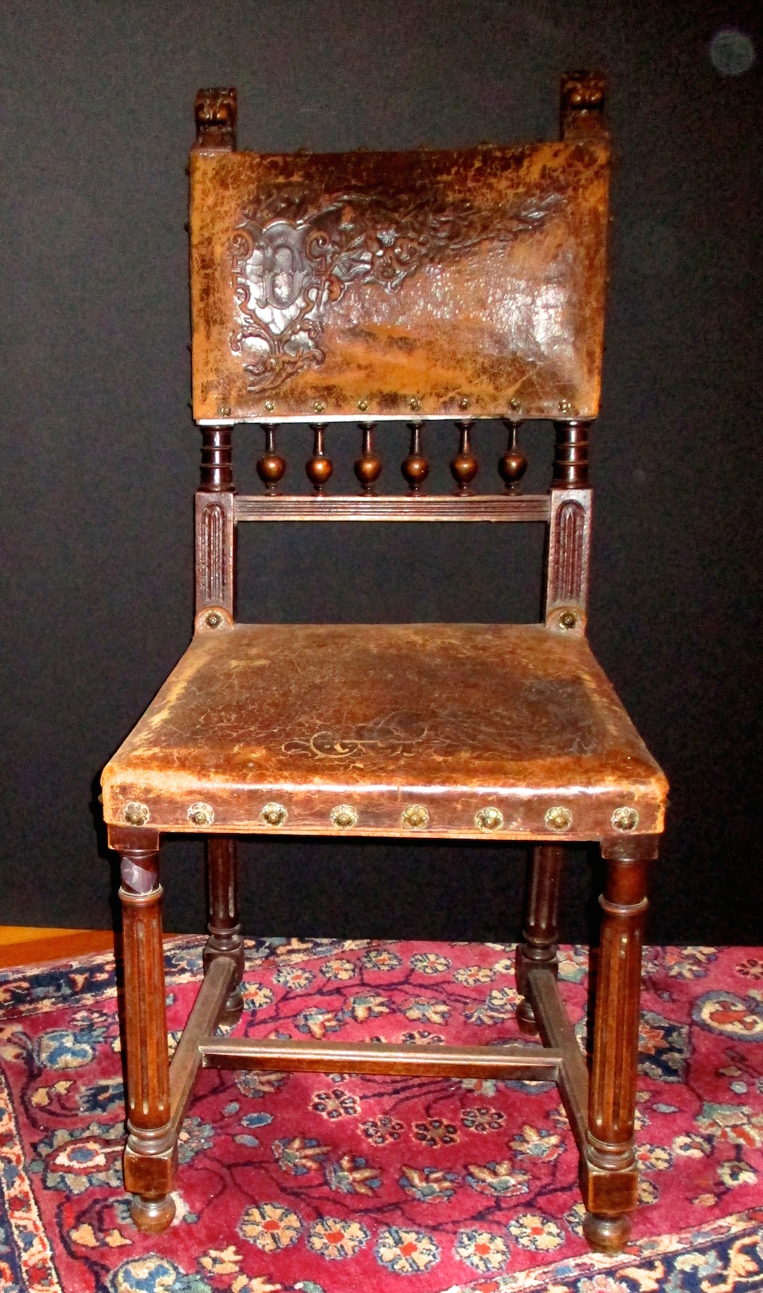 One of a Pair of Worn Leather Upholstered Chairs (Back is Tooled Leather) - (17" W x 37 1/2" H x 16" D)
